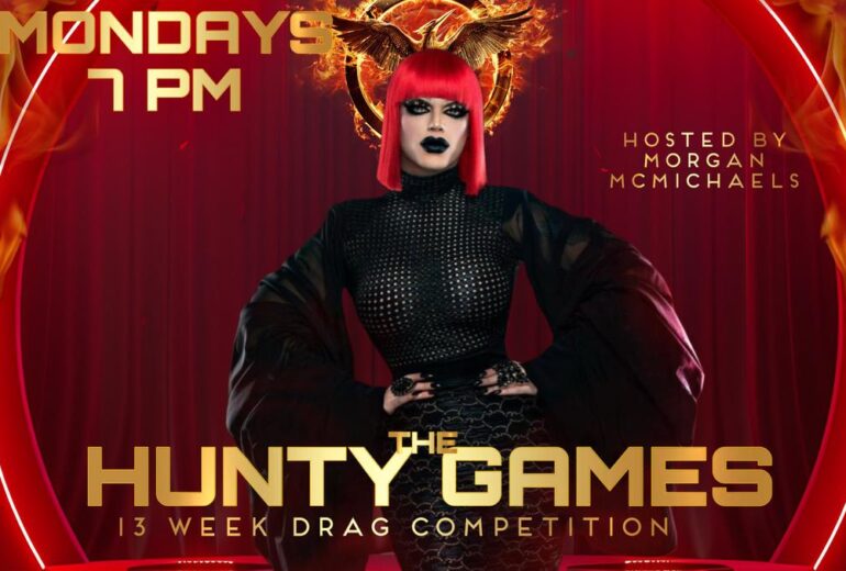 A promotional poster for "The Hunty Games" at Micky's West Hollywood. The poster features a drag queen with a red wig and a black outfit against a red background with flames. The text includes "MONDAYS 7 PM", "HOSTED BY MORGAN MCMICHAELS", and "THE HUNTY GAMES 13 WEEK DRAG COMPETITION".